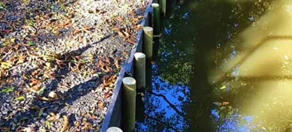 Recycled plastic planks used as stabilising edging for this pond in Bromsgrove