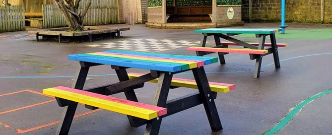 Multicoloured recycled plastic Holmfirth tables in the playground at Riverside Junior School in Hebden Bridge