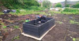 Fitting the cross-supports inside the raised bed.