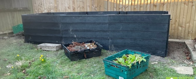 An almost-finished recycled plastic raised bed kit.