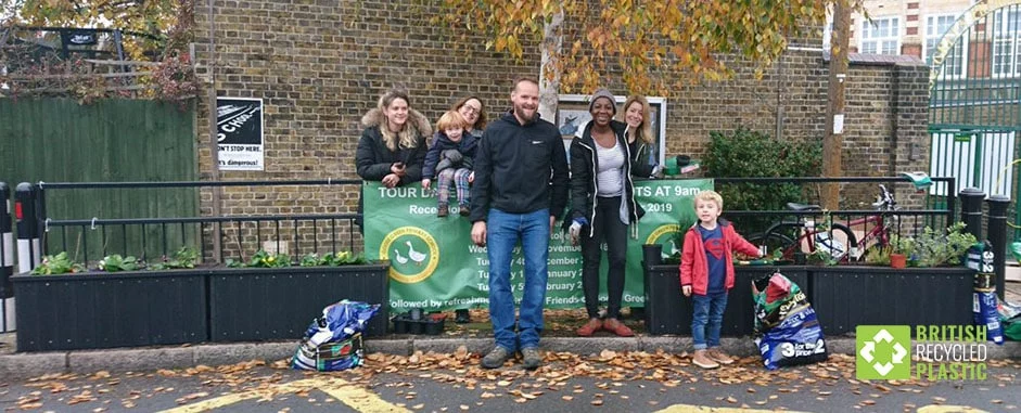 People at Goose Green Primary Scholl planting a smog shield at the entrance in recycled plastic planters