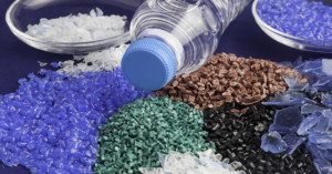 Variety of plastic pellets with a plastic water bottle