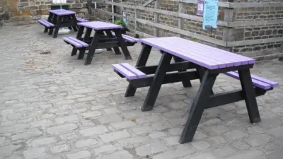 Two women at a rainbow table. Bradshaw picnic table
