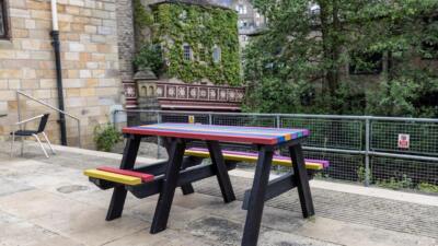 A rainbow coloured Bradshaw wheelchair accessible recycled plastic picnic table, donated to Hebden Bridge Community Association to celebrate Pride Week in 2021.