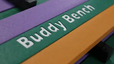 Colourful bench with 'Buddy Bench' inscription. British Recycled Plastic