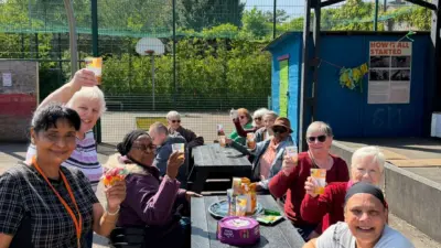 Community group enjoying chats sat at a British Recycled Plastic Denholme Picnic Table