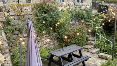 Quaint garden with picnic table and lights. British Recycled Plastic