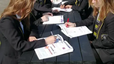 Students studying outdoors at British Recycled Plastic picnic table.