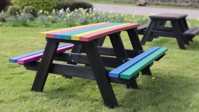 Multicoloured Denholme picnic table next to a brown Denholme table
