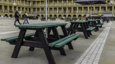 Recycled plastic picnic tables in piece hall courtyard. Green