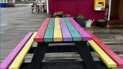 Colourful recycled plastic picnic table on pier