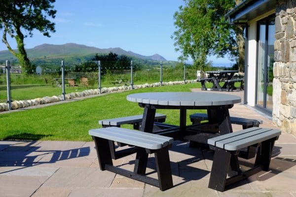 A black and grey recycled plastic circular 8 seater Calder picnic table