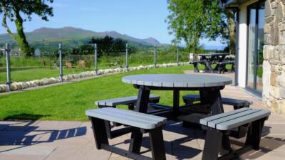 A black and grey recycled plastic circular 8 seater Calder picnic table