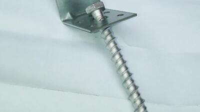 Ground fixing anchors for hard surfaces