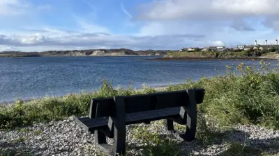 Black Harewood bench in the Outer Hebrides looking out to see