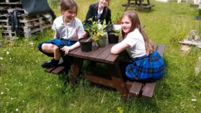 Three girls sitting at Holmfirth British Recycled plastic picnic table