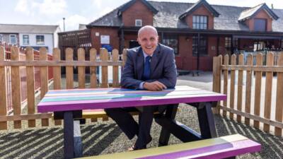 Holmfirth picnic table with a smiling teacher