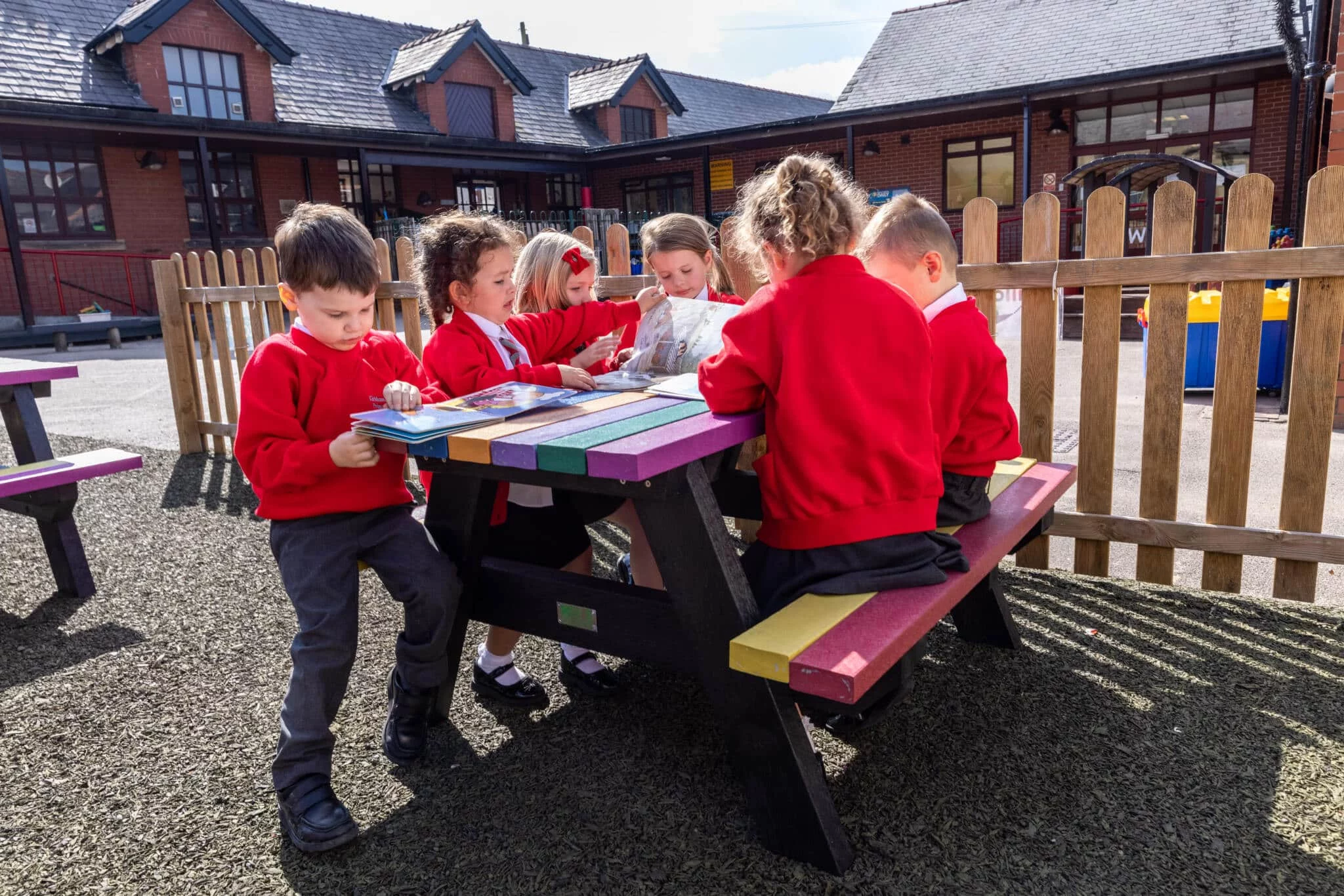 Holmfirth picnic table at Kirkham and Wesham Primary School – with kids playing 01 (1) Holmfirth table with kids writing