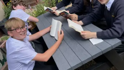 Students reading together outside school at a British Recycled Plastic Table