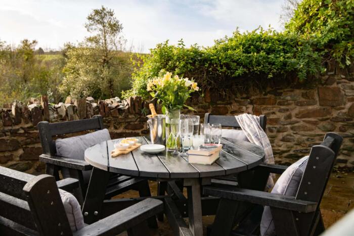Roundhay dining set - Old Landswarnick British Recycled Plastic Roundhay dining set in a UK garden