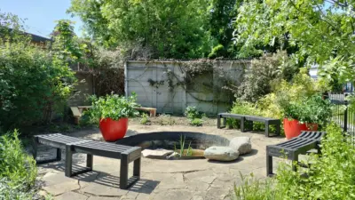 Garden seating area with planters. British Recycled Plastic Skipton Curve Benches