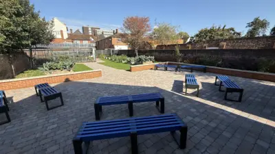 Outdoor seating area with blue benches. British Recycled Plastic