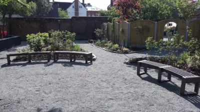 Quiet garden with curved benches and plants. British Recycled Plastic