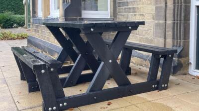 The Batley "walkthrough" recycled plastic picnic table is key part of our accessibility range of furniture as less mobile users can get to the seats without having to lift their legs very much. This table is at the Overgate Hospice in Elland, West Yorkshire.