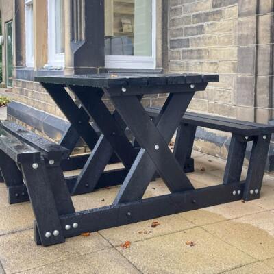 The Batley "walkthrough" recycled plastic picnic table is key part of our accessibility range of furniture as less mobile users can get to the seats without having to lift their legs very much. This table is at the Overgate Hospice in Elland, West Yorkshire.