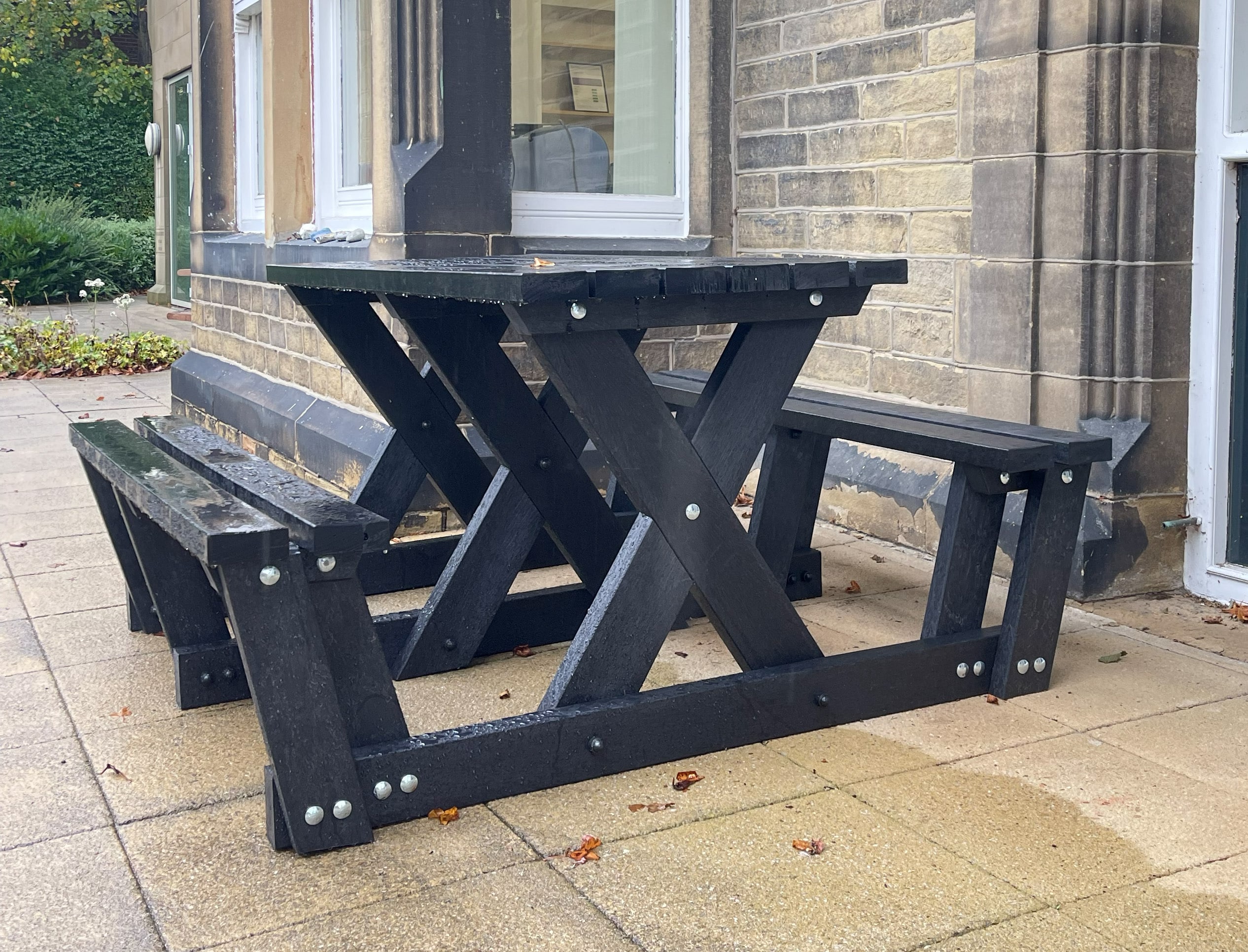 The Batley "walkthrough" recycled plastic picnic table is key part of our accessibility range of furniture as less mobile users can get to the seats without having to lift their legs very much. This table is at the Overgate Hospice in Elland, West Yorkshire.