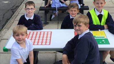 children smiling at an otley table