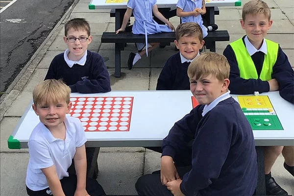children smiling at an otley table