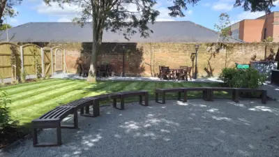 Garden seating area with curved benches. British Recycled Plastic