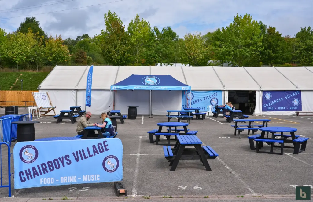 Outdoor seating area with event tents at Wycombe Wandererd