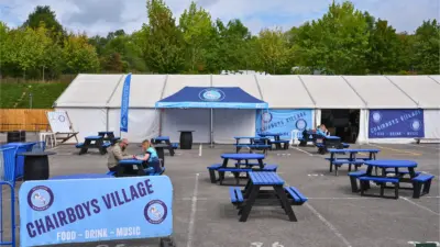 Outdoor seating area with event tents at Wycombe Wandererd