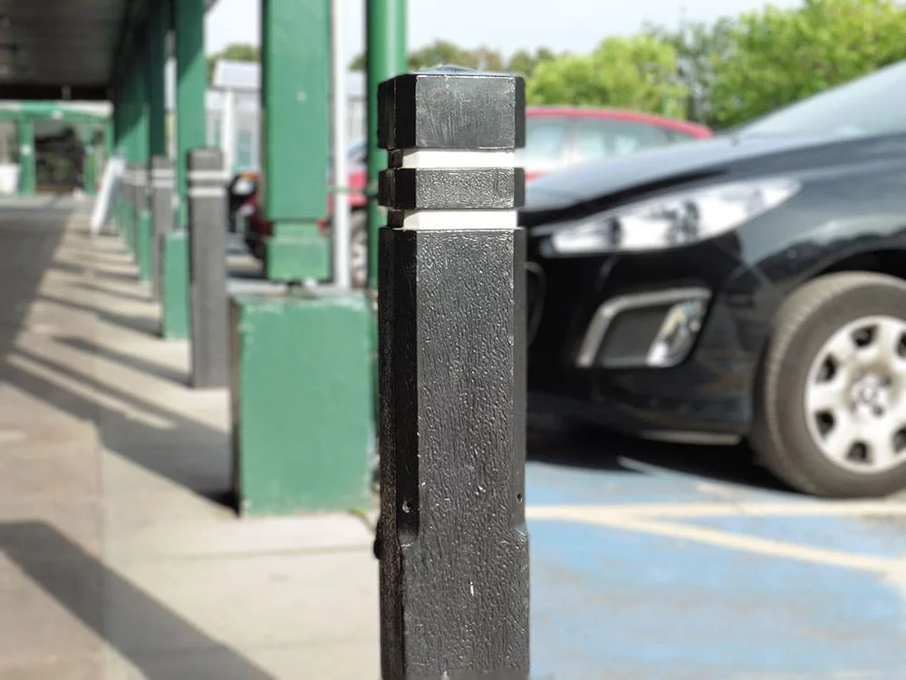 A Brighouse recycled plastic square bollard with white and red reflective strips in a Morrisons car park