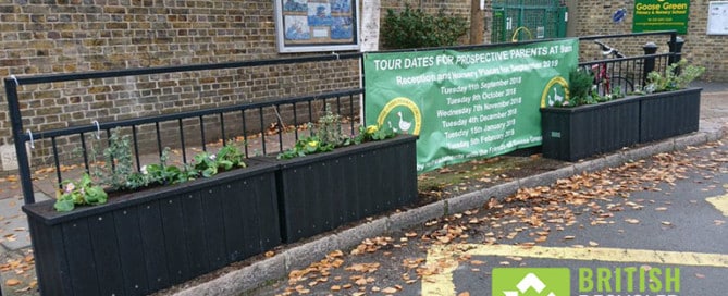 Recycled plastic planters in use outside a school