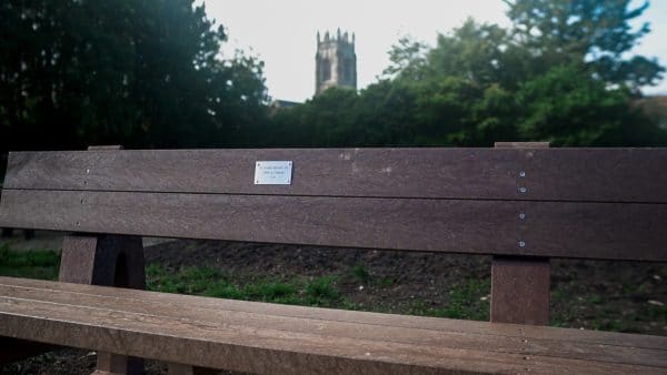 A brown recycled plastic Harewood memorial bench in Driffield, East Yorkshire