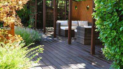 Brown recycled plastic rot-proof decking with a 25 year guarantee installed on this beautiful patio