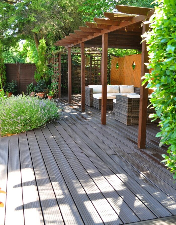 Brown recycled plastic rot-proof decking with a 25 year guarantee installed on this beautiful patio