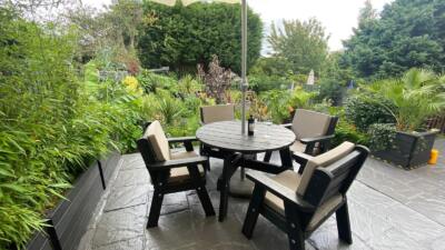 The recycled plastic Roundhay garden dining set in a private garden, guaranteed for 25 years