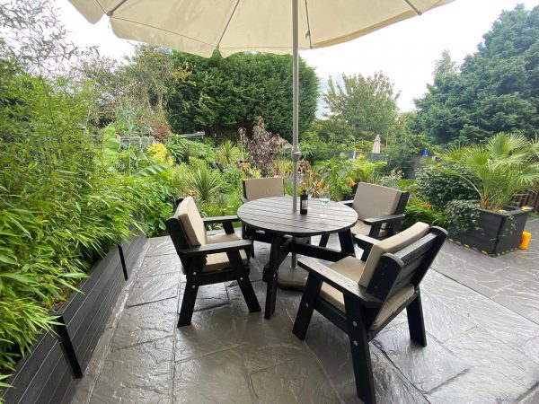 The recycled plastic Roundhay garden dining set in a private garden, guaranteed for 25 years