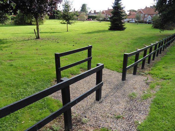 Recycled plastic lumber planks and posts used to make a post-and-rail fence for a village green in Yorkshire