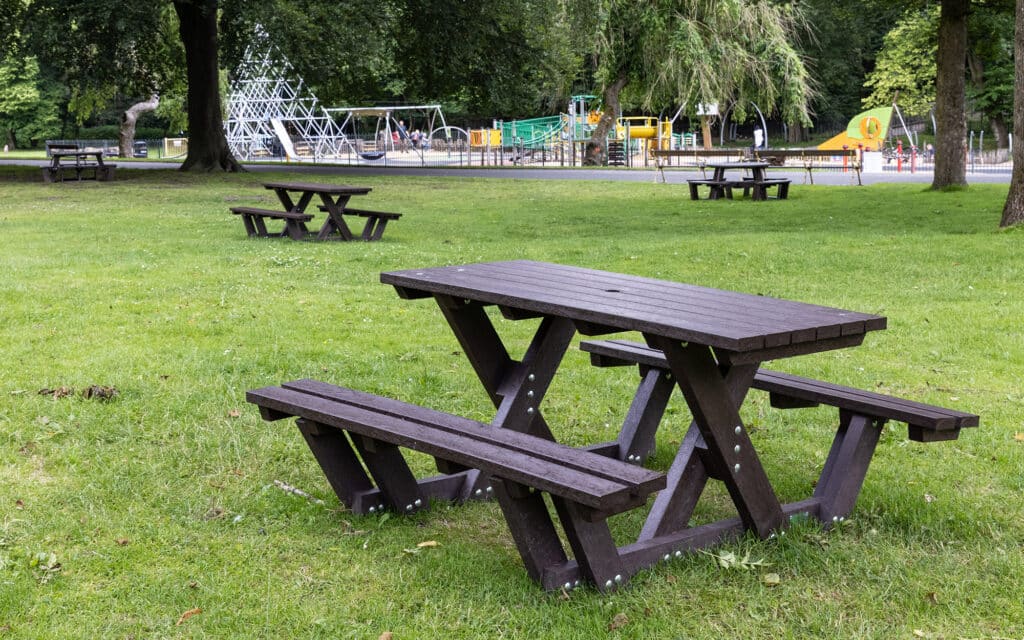 An array of recycled plastic Batley 'walk through' picnic tables at Queens Park, Bolton