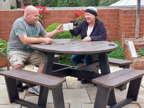 After assembling their recycled plastic Calder picnic table, the workers pause for a well-earned brew