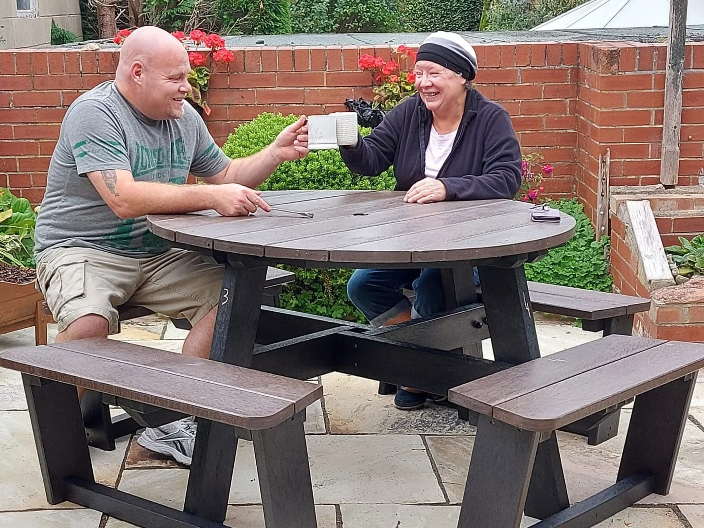 After assembling their recycled plastic Calder picnic table, the workers pause for a well-earned brew