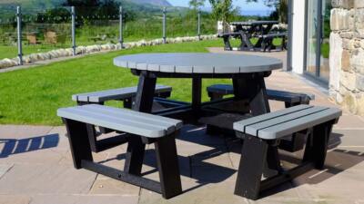 A black and grey recycled plastic circular 8 seater Calder picnic table