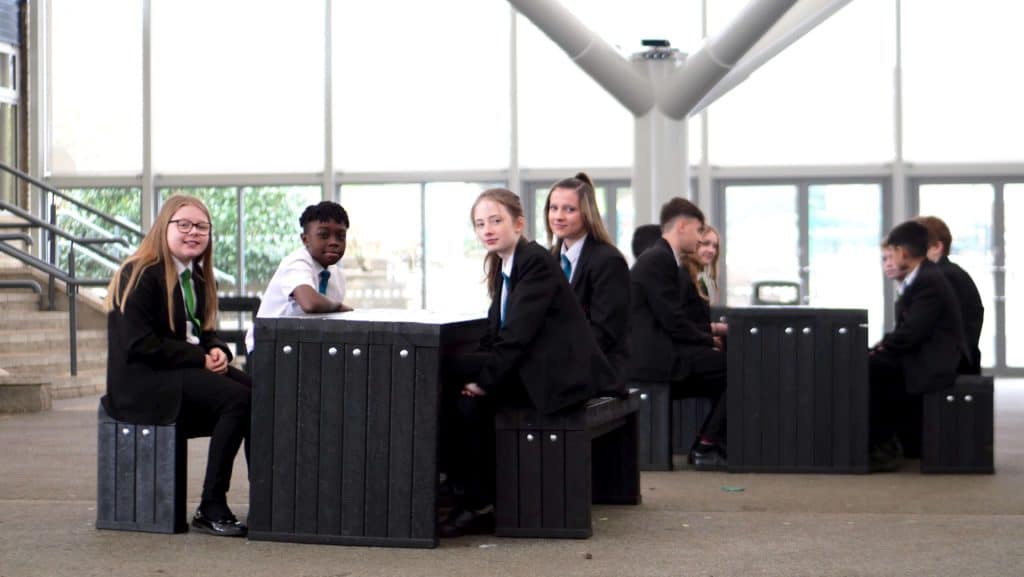 Pupils at Rastrick High School, using recycled plastic furniture