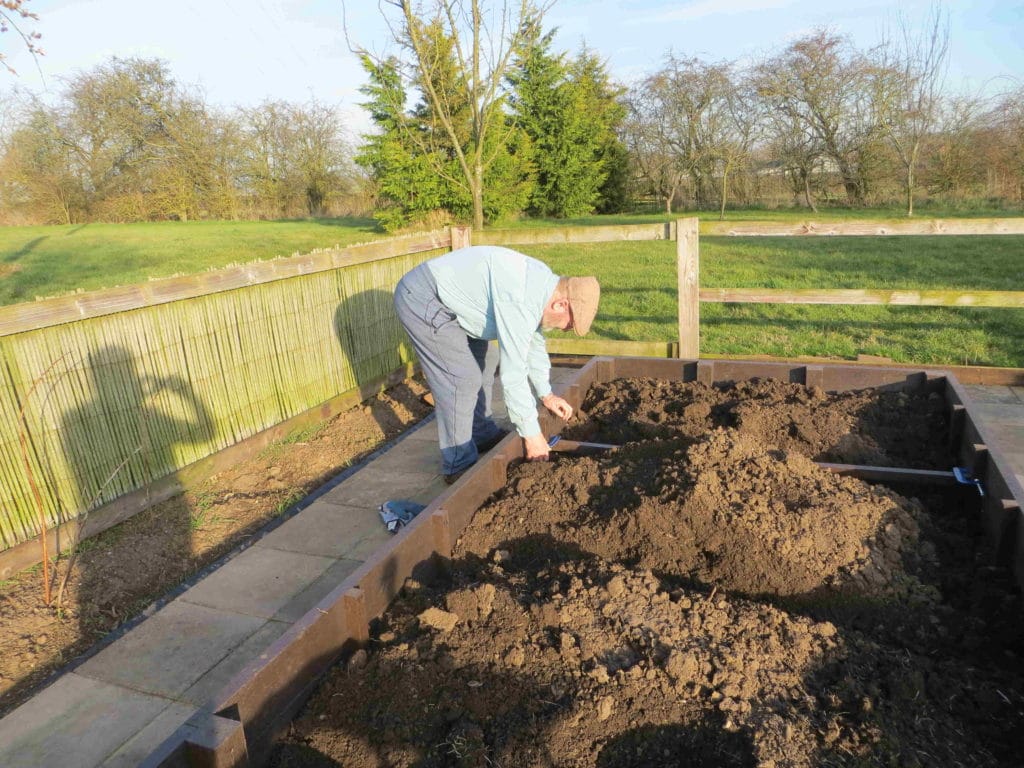 Chris Fone building recycled plastic raised bed