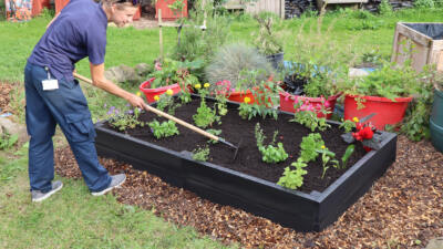 Matryna tending recycled plastic raised bed